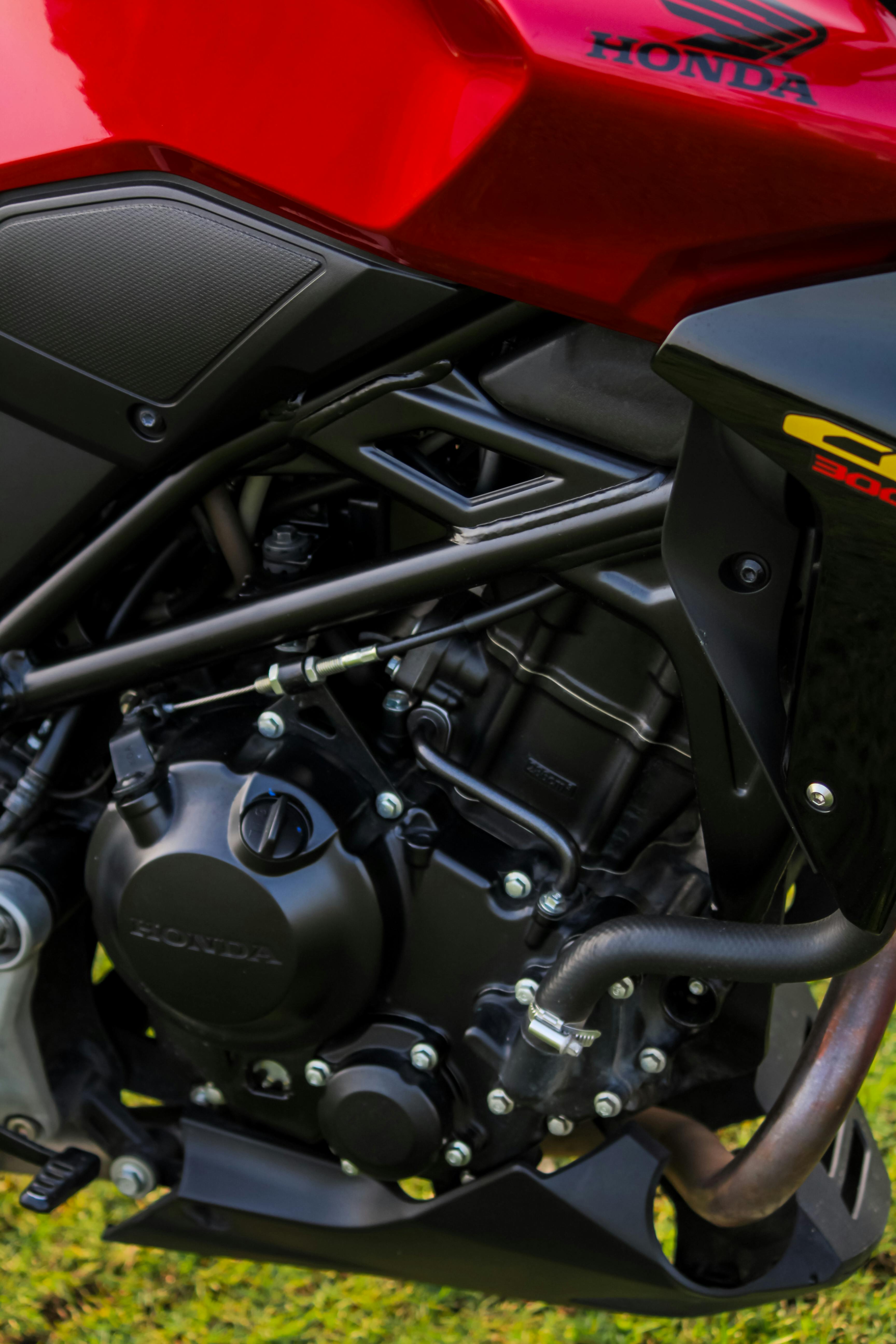 Close-up of a modern Honda motorcycle engine showcasing intricate mechanical details outdoors in Kochi.