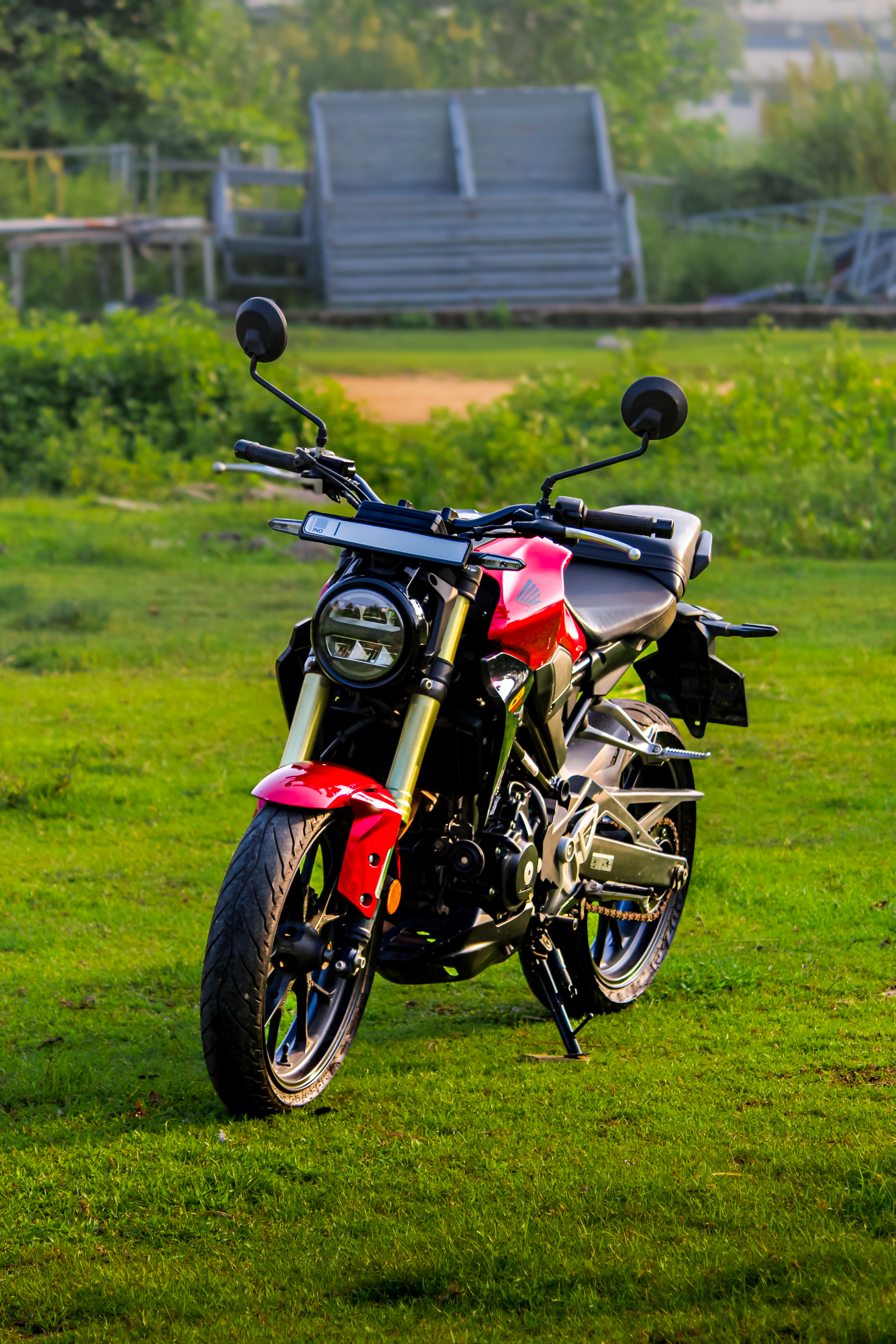 Vibrant Red Motorcycle in Lush Green Field · Free Stock Photo