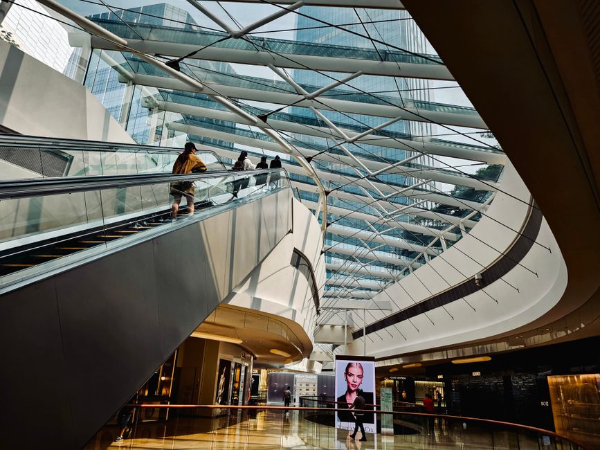 Spacious interior of Albrook Mall in Panama City, with various shops and shoppers