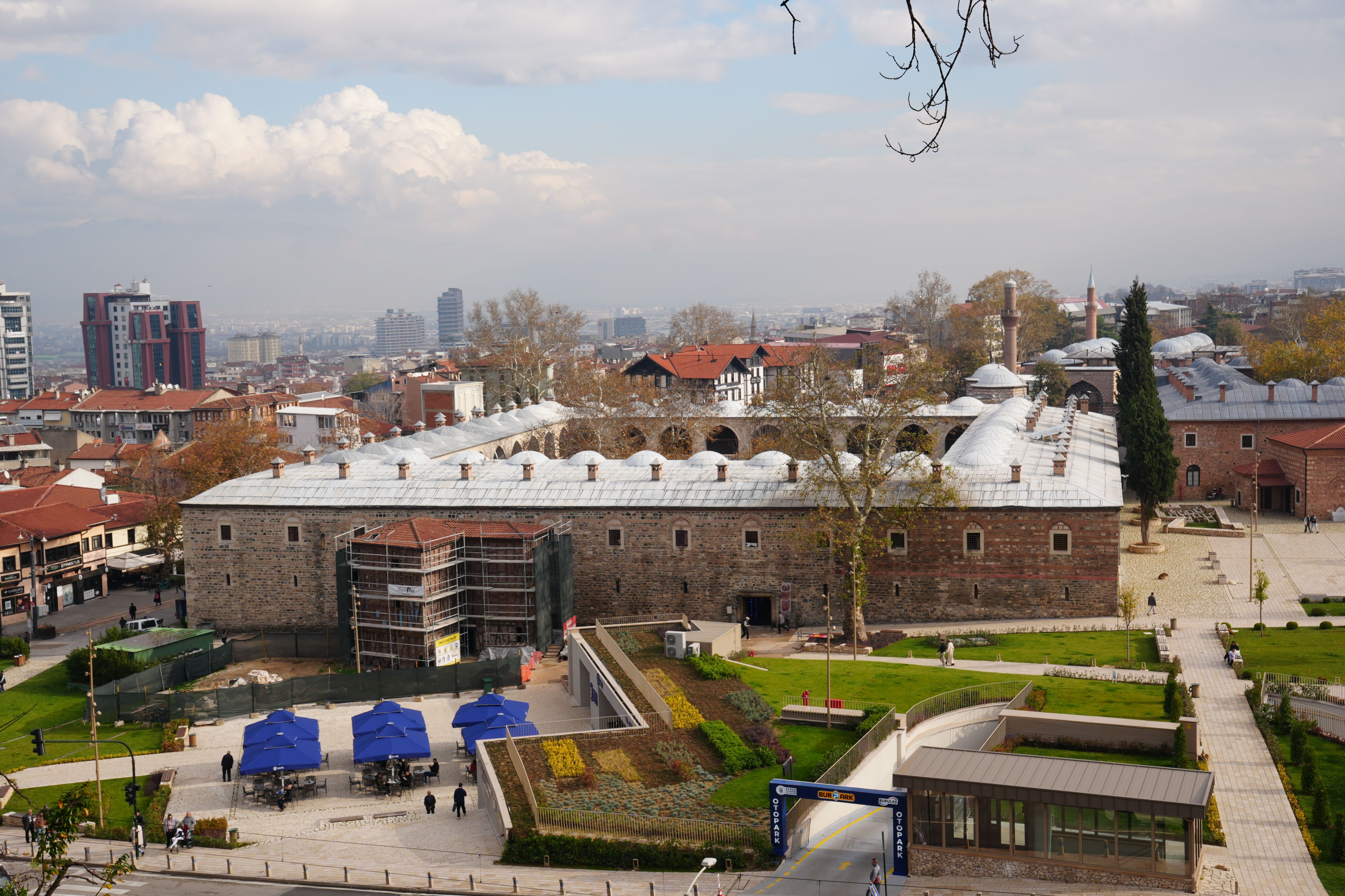 Aerial view of Koza Han in Bursa, Turkey, showcasing the historic architecture and surrounding urban landscape.