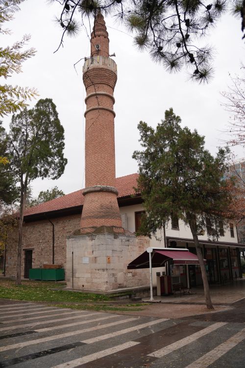 Free A beautiful historical brick minaret with trees in a peaceful outdoor space, perfect for architecture enthusiasts. Stock Photo