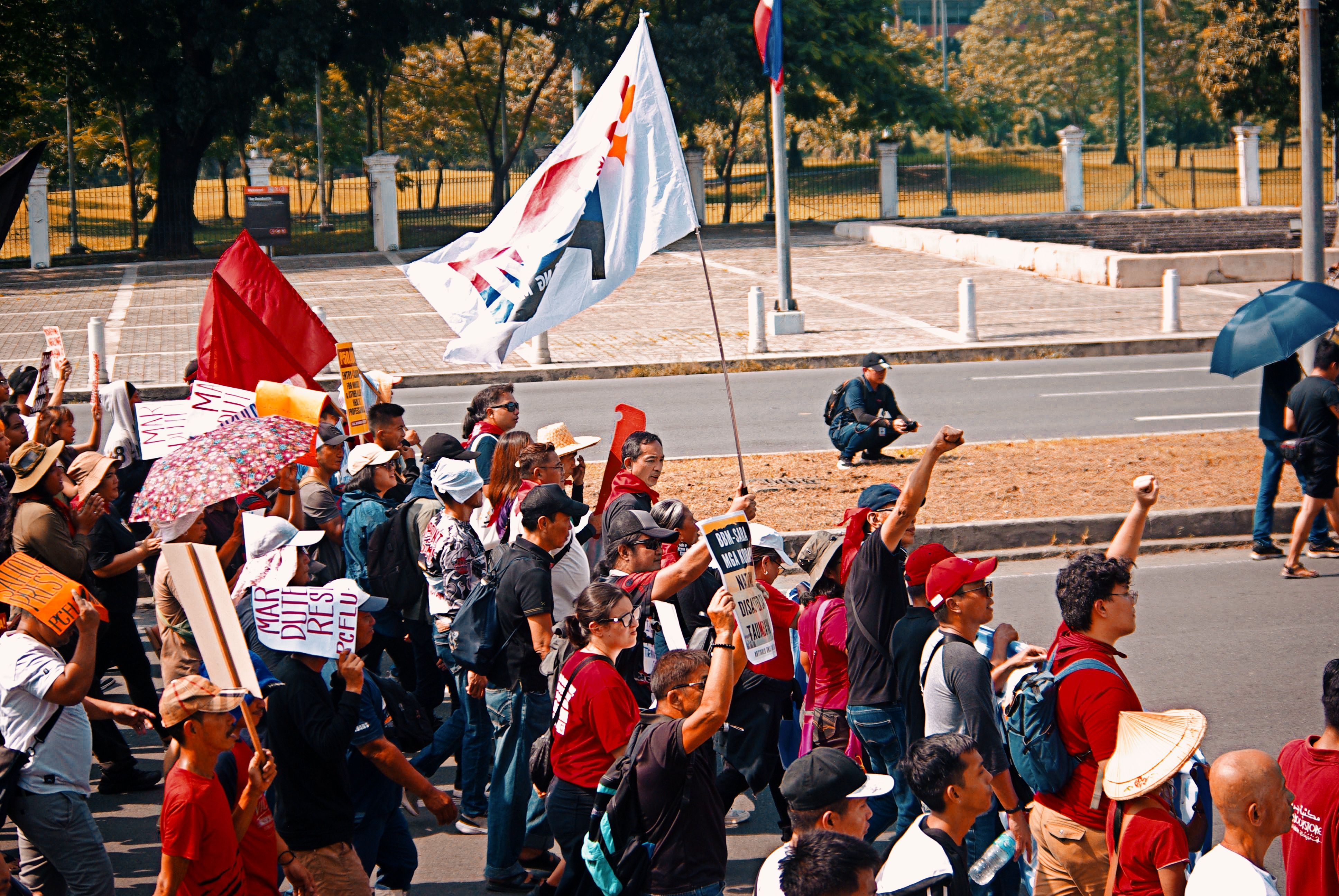 Crowded Street Protest with Colorful Banners · Free Stock Photo