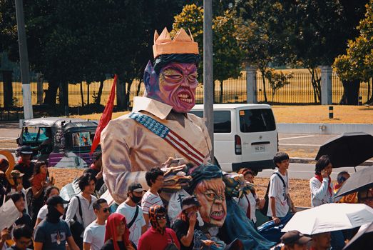 Vibrant parade with a large puppet and crowd outdoors. Energetic, lively cultural celebration.