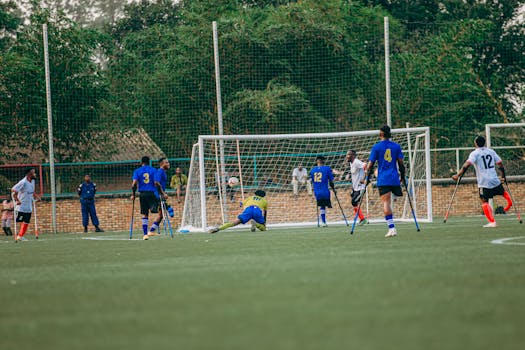 Action shot of a competitive Paralympic soccer match in Burundi with determined athletes.