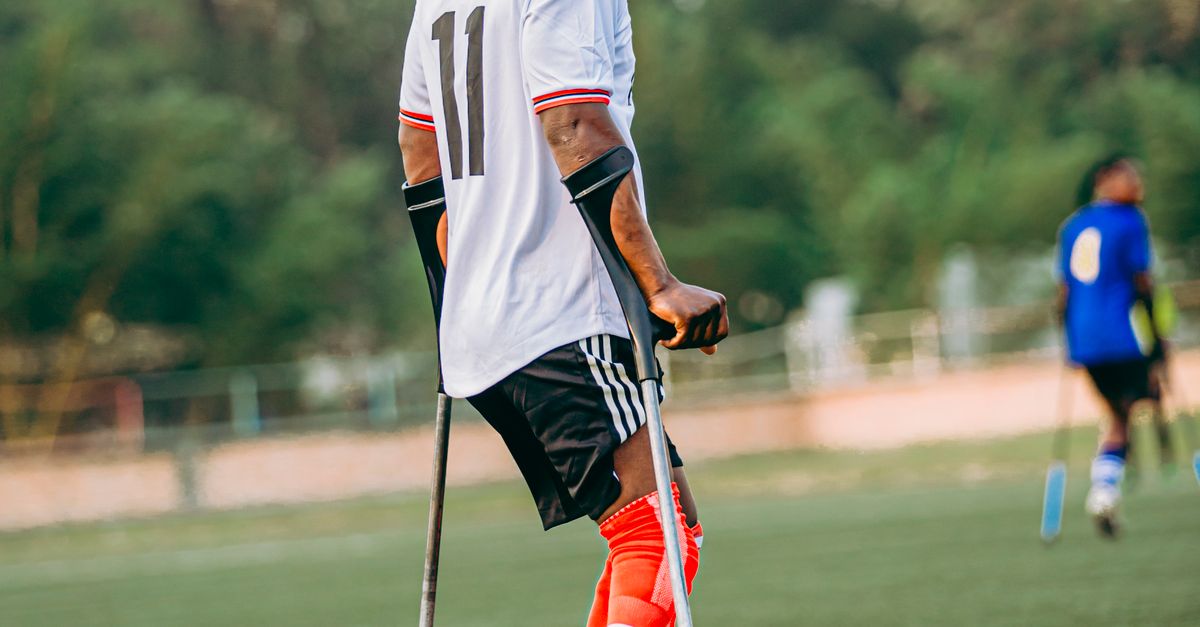 Adaptive Soccer Player On Field With Crutches Free Stock Photo adaptive-soccer-player-on-field-with-crutches-free-stock-photo