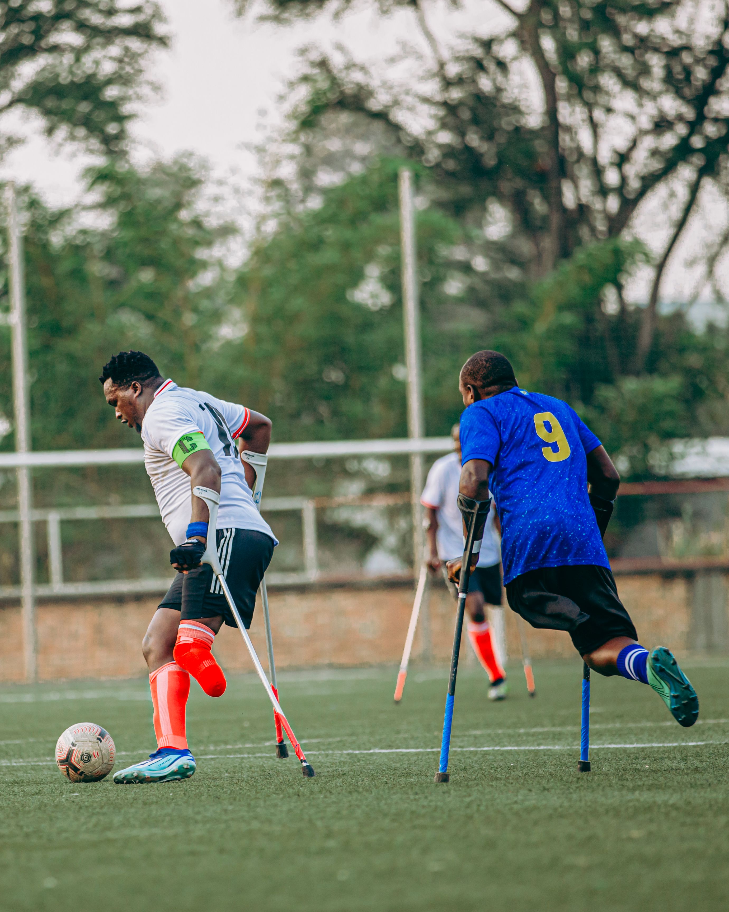 Inspiring Amputee Football Match on Grass Field · Free Stock Photo