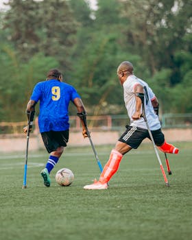 Amputee soccer players compete in a vibrant outdoor match, showcasing determination.