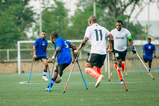 Dynamic outdoor amputee soccer match showcasing athletes' skills and teamwork.