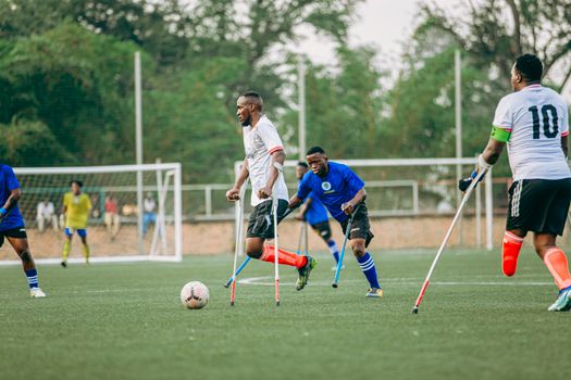Amputee soccer players engaging in a lively match, showcasing skill and determination.