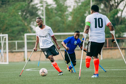 Amputee football players in action during a competitive match, showcasing determination and teamwork.