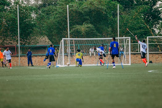 Amputee football match showcasing players in action on a sunny day, emphasizing inclusivity in sports.