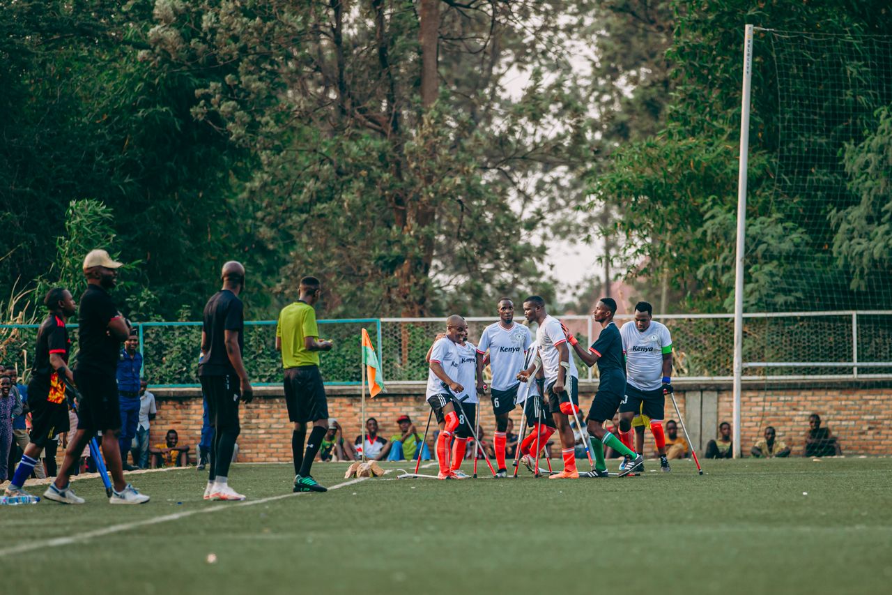 group of amputee athletes playing soccer on a field during daytime
