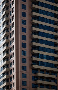 Close-up of a modern high-rise building showcasing architectural design with glass and balconies.