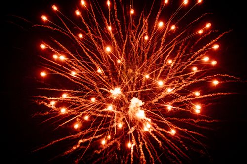 Free A stunning explosion of orange fireworks lighting up the night sky, creating a vibrant display. Stock Photo