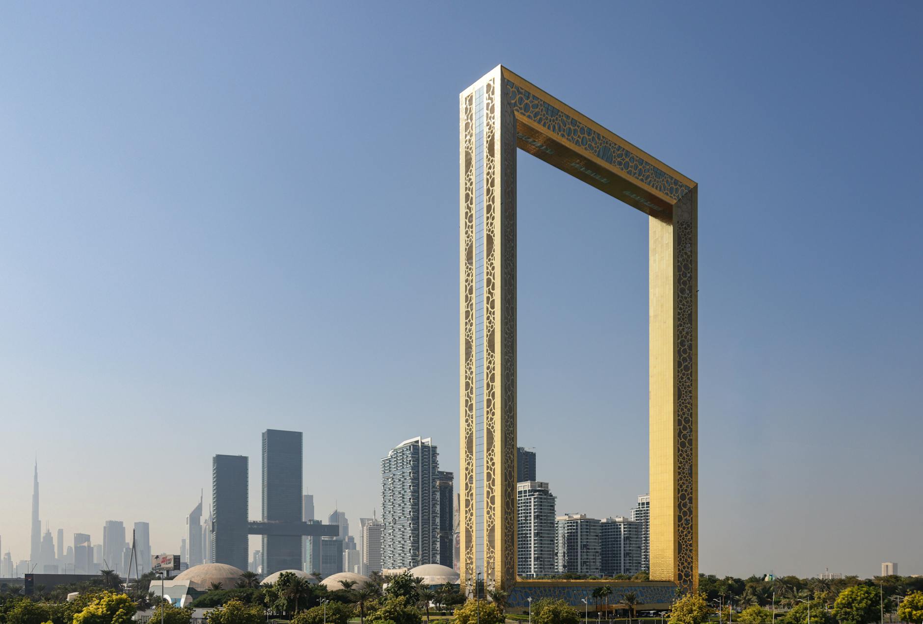 Dubai skyline with the Dubai Frame in the foreground at sunset, representing modern growth and community life in the UAE – UAEThrive.