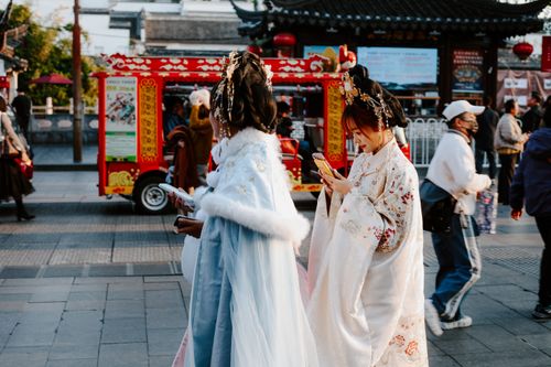 Free People in traditional attire on a vibrant street in Nanjing, capturing a moment of Chinese culture. Stock Photo