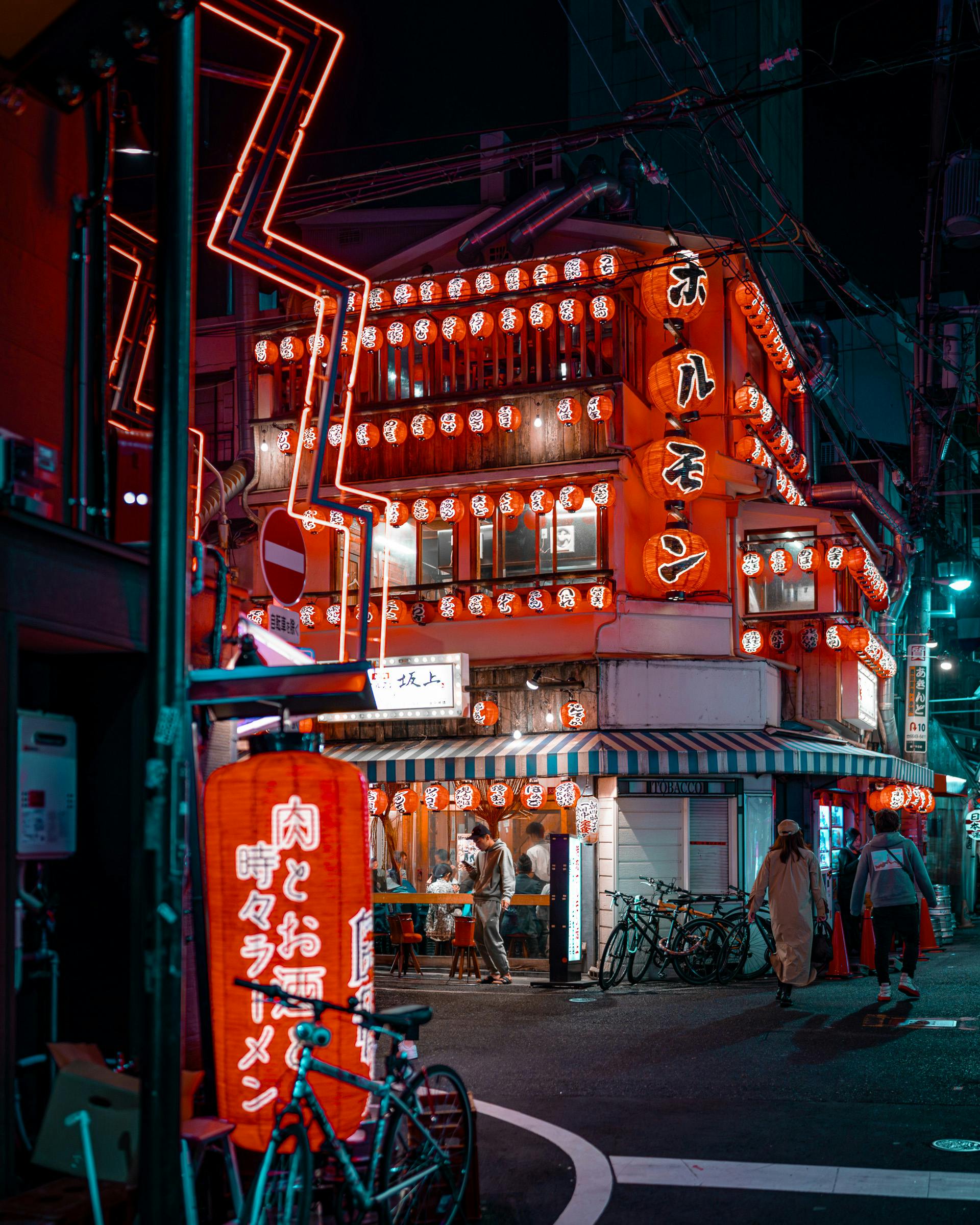 Colorful neon lights and bustling streets in Osaka at night.