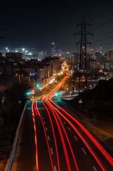 Captivating urban night view featuring vibrant light trails on a busy road.