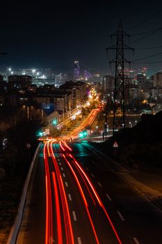 Dynamic city nightscape featuring vibrant light trails and illuminated skyline.