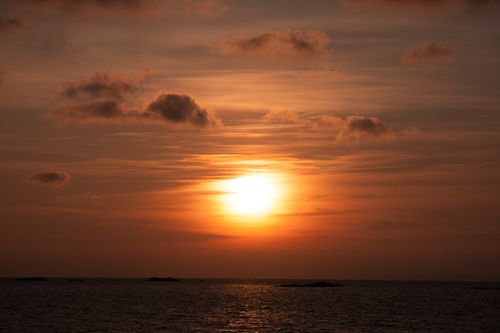 Free Breathtaking sunrise with warm autumn tones over a calm ocean horizon, capturing natural beauty. Stock Photo