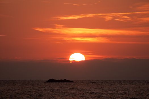 Gorgeous sunrise over the Long Island Sound with vibrant orange hues and calm waters.