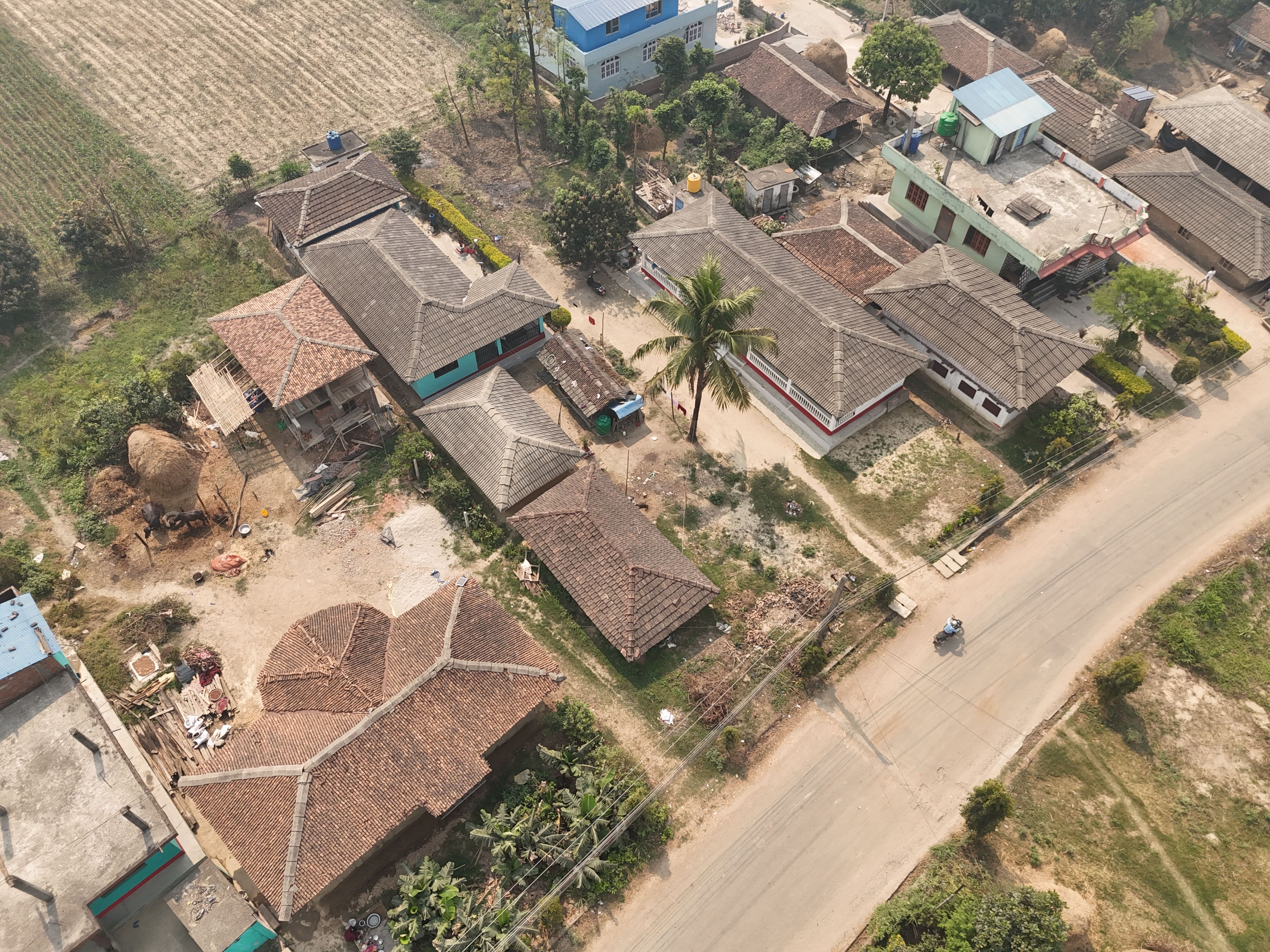 Unbeatable Everest Base Camp & Kala Patthar Landing Helicopter Tour Review 2026 - Aerial view showcasing traditional rural houses and a road in a Nepali village.