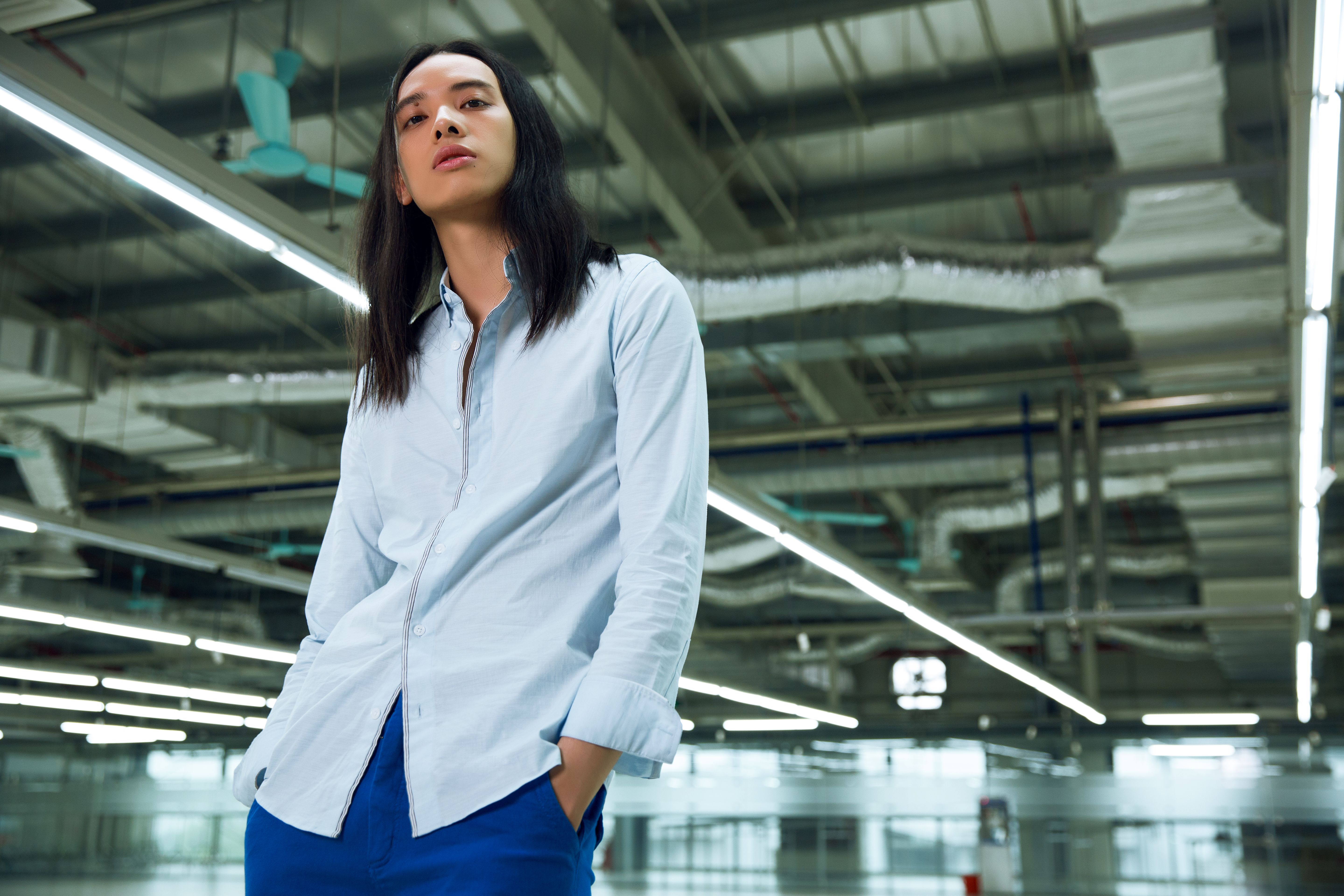 Stylish Young Adult in Modern Industrial Setting