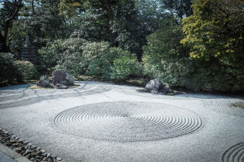 Free A tranquil Japanese Zen garden with raked sand and rocks, embodying serenity and nature's balance. Stock Photo