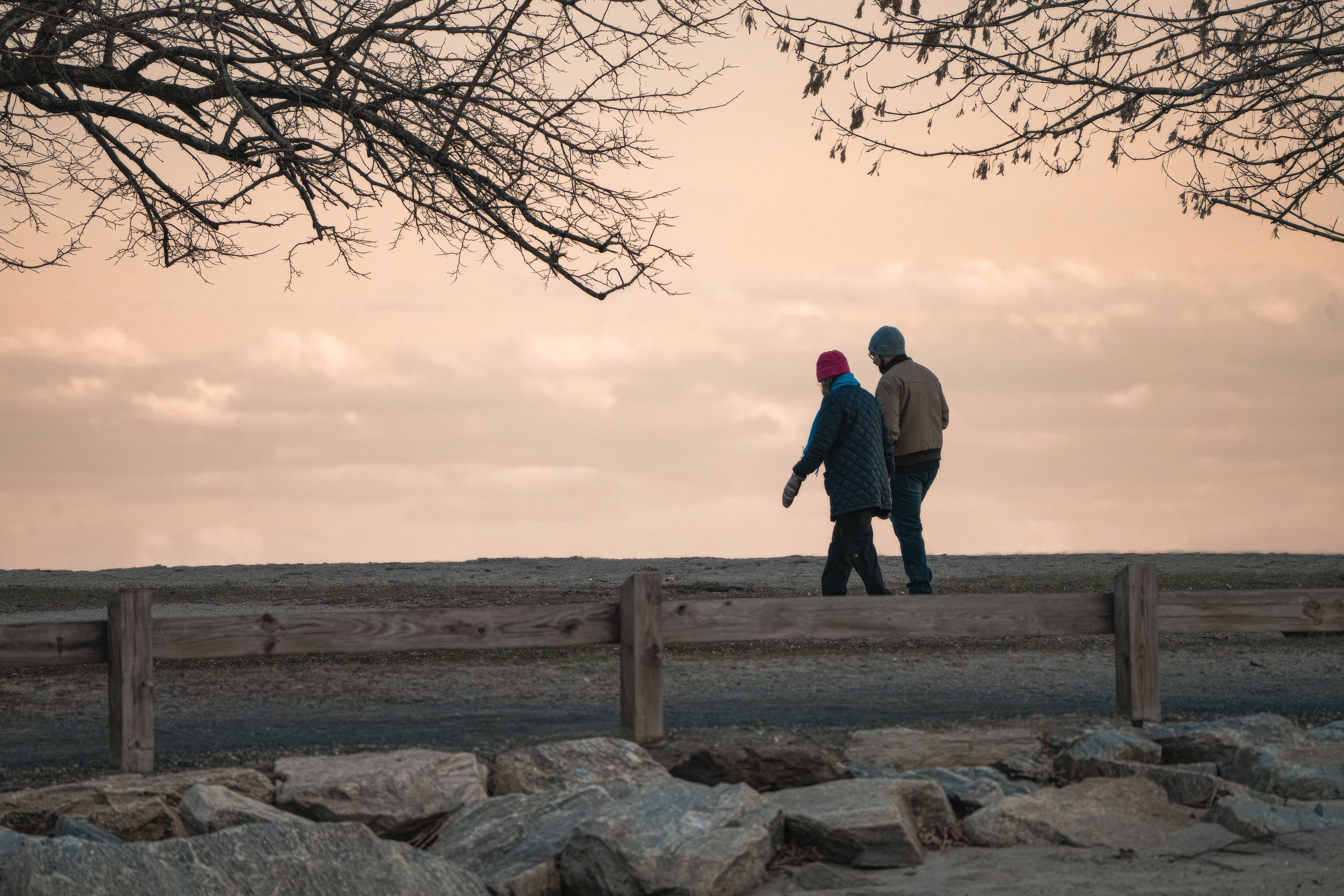 Elderly Couple Walking at Sunset in Autumn Park · Free Stock Photo