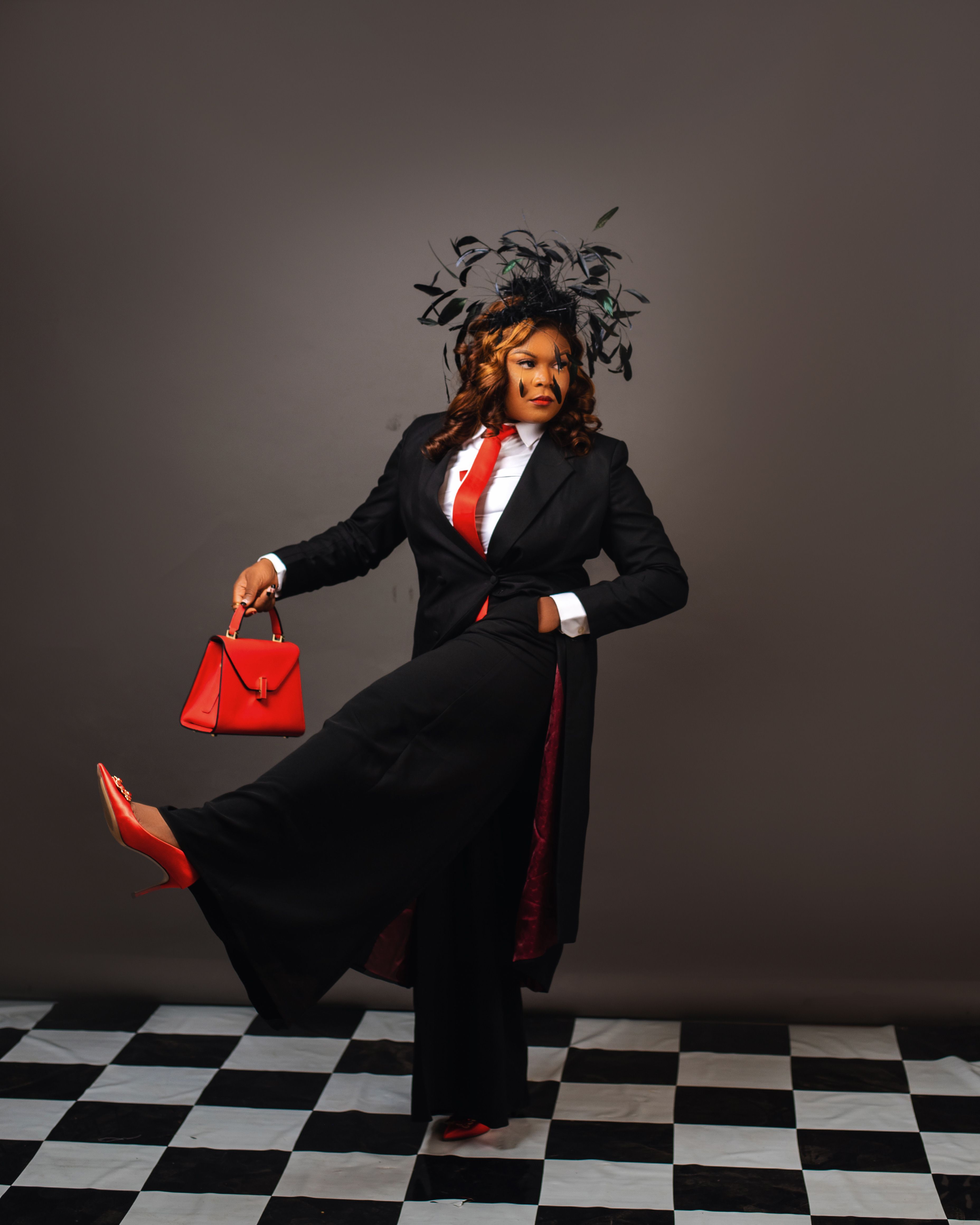 Elegant Woman in Black Suit with Red Accessories · Free Stock Photo
