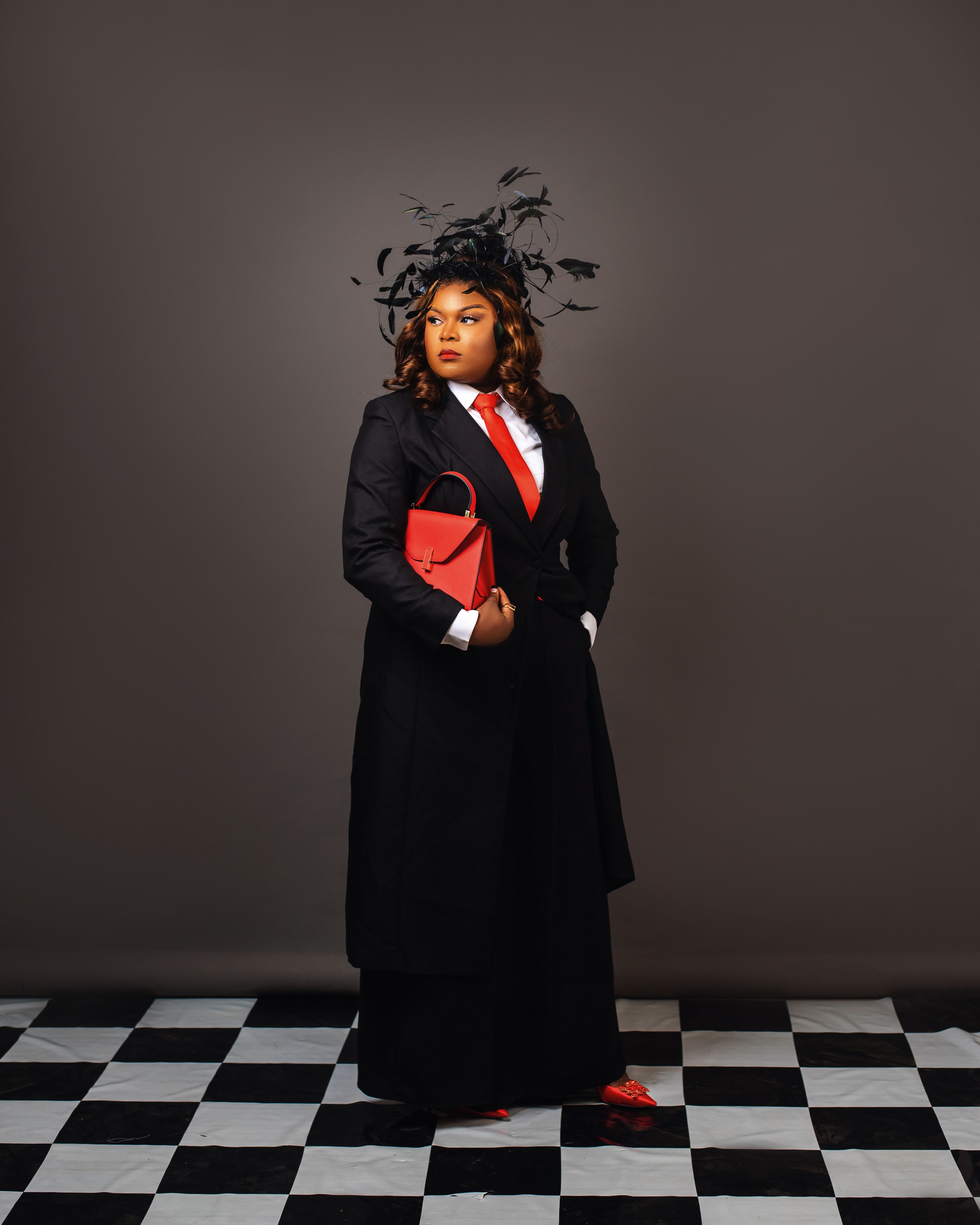 Elegant Woman in Black Suit with Red Accessories · Free Stock Photo