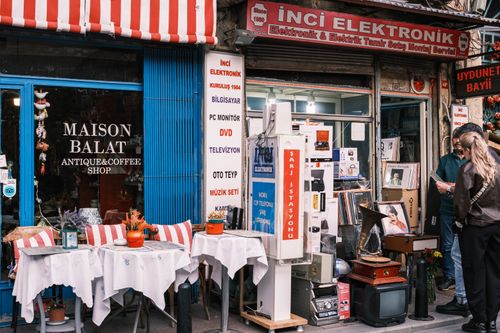 Free Street view capturing Maison Balat, a quaint antique and coffee shop in a bustling area. Stock Photo