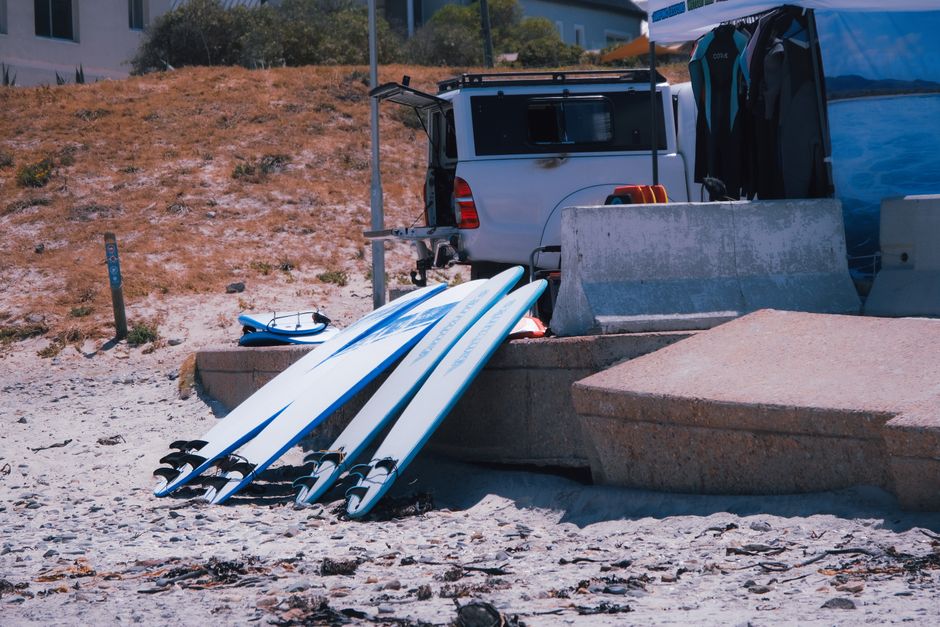 A sunny day at the beach with surfboards prepared for an adventure by the sea.
