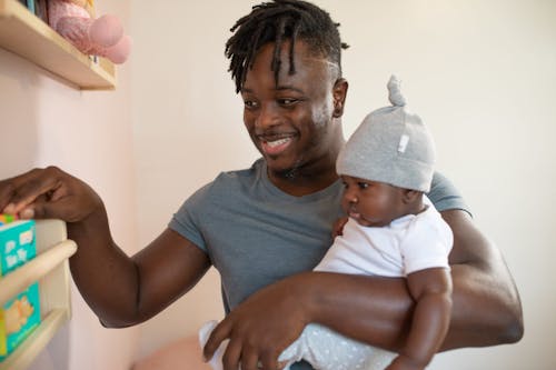 Free Man Carrying His Baby Stock Photo