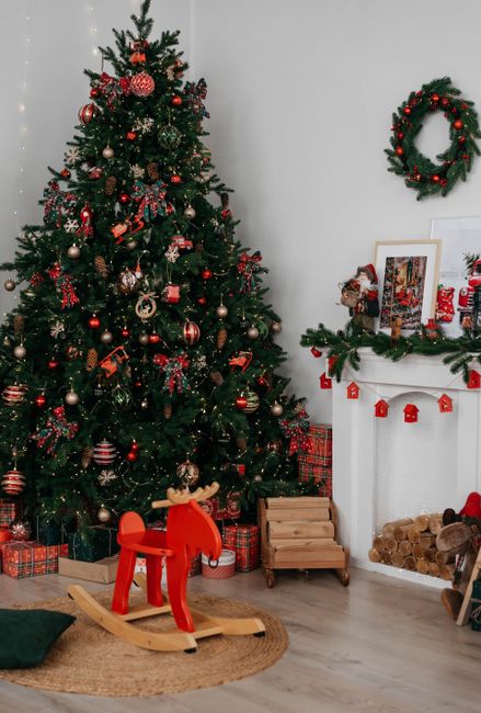 A festive living room featuring a beautifully decorated Christmas tree and cozy fireplace.