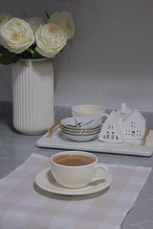Free Sophisticated coffee setting with white roses and porcelain decor on a marble surface. Stock Photo