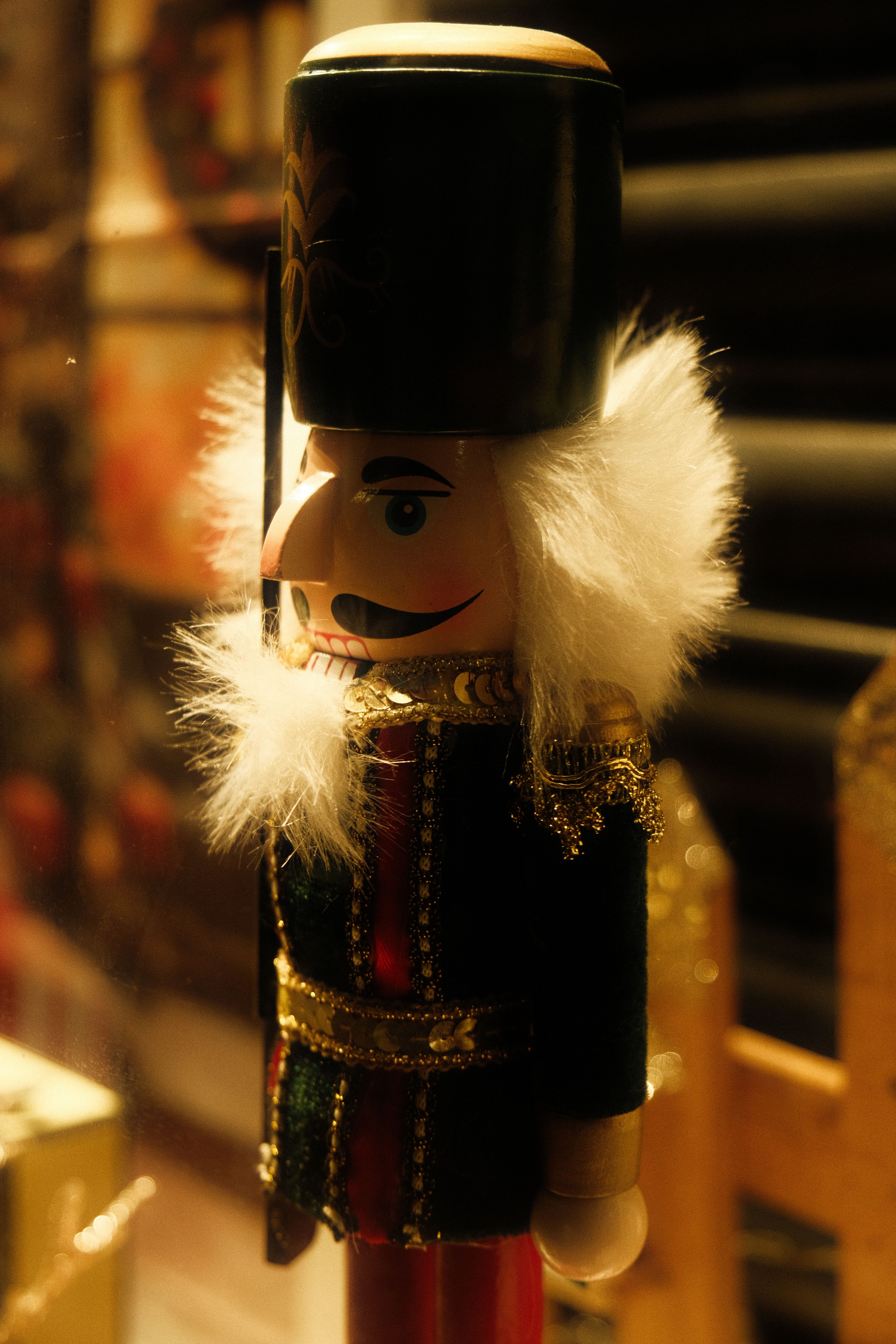 A festive close-up of a traditional nutcracker soldier with golden details.