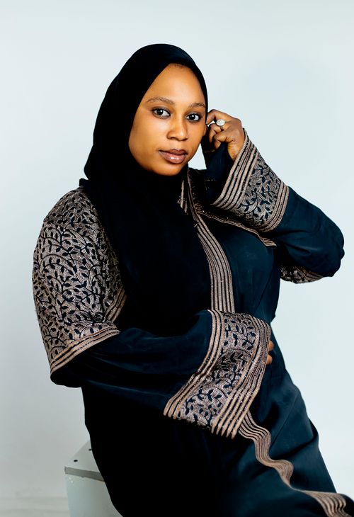 Free Portrait of a woman in a beautifully embroidered black abaya showcasing elegance. Stock Photo