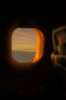 Captivating sunset view from airplane window, showcasing serene aerial beauty and travel allure.