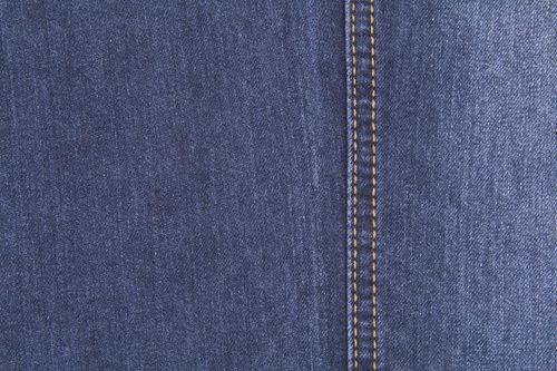 Free Detailed closeup view of blue denim fabric showcasing texture and stitching. Stock Photo