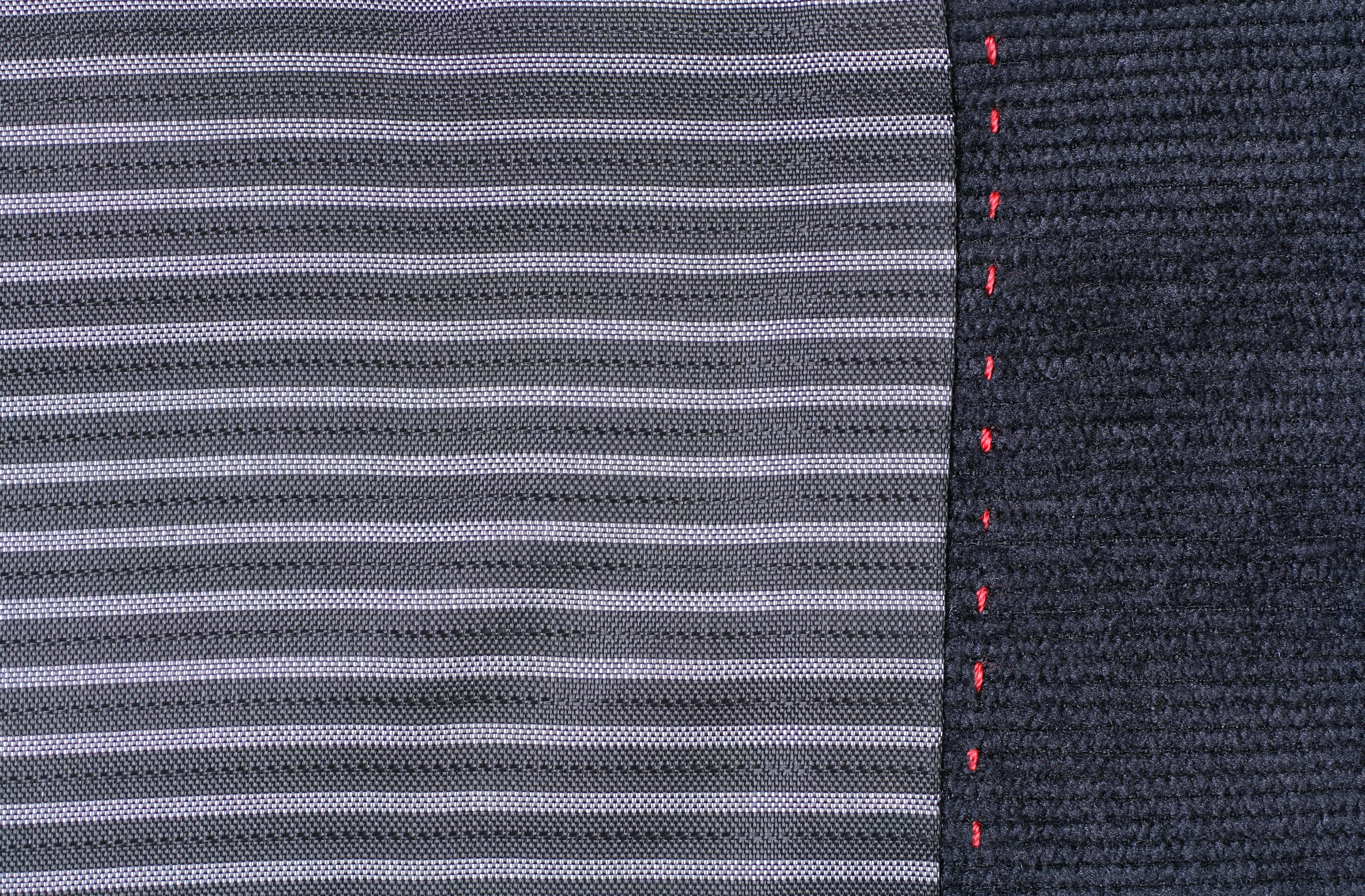 A close-up of inset stitched edges on a professional gaming mat - board game mat