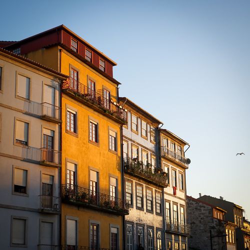 Free A row of colorful urban buildings captured at sunset, highlighting vibrant architecture. Stock Photo