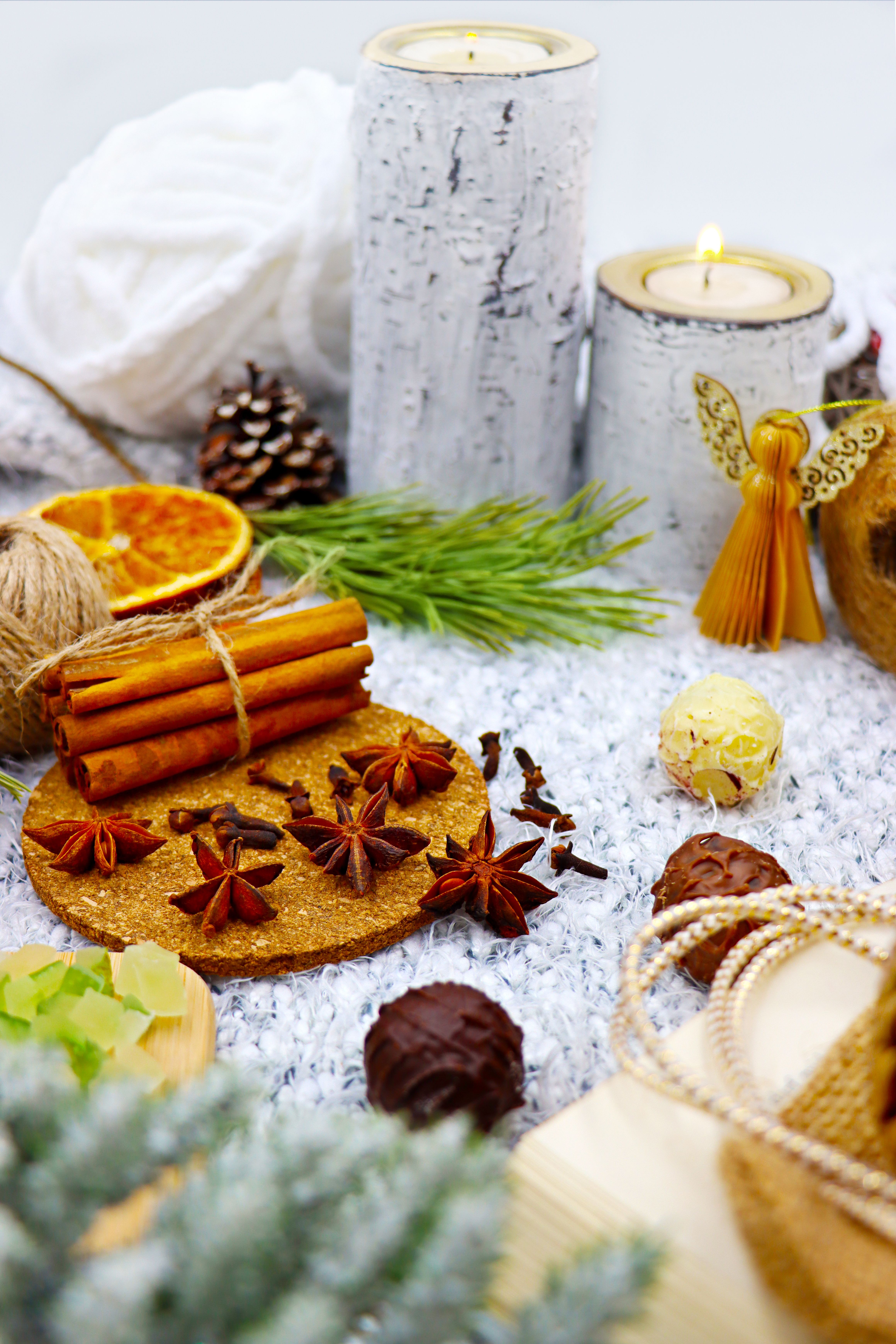 Cinnamon sticks, star anise, cloves and candles arranged as a Christmas centerpiece