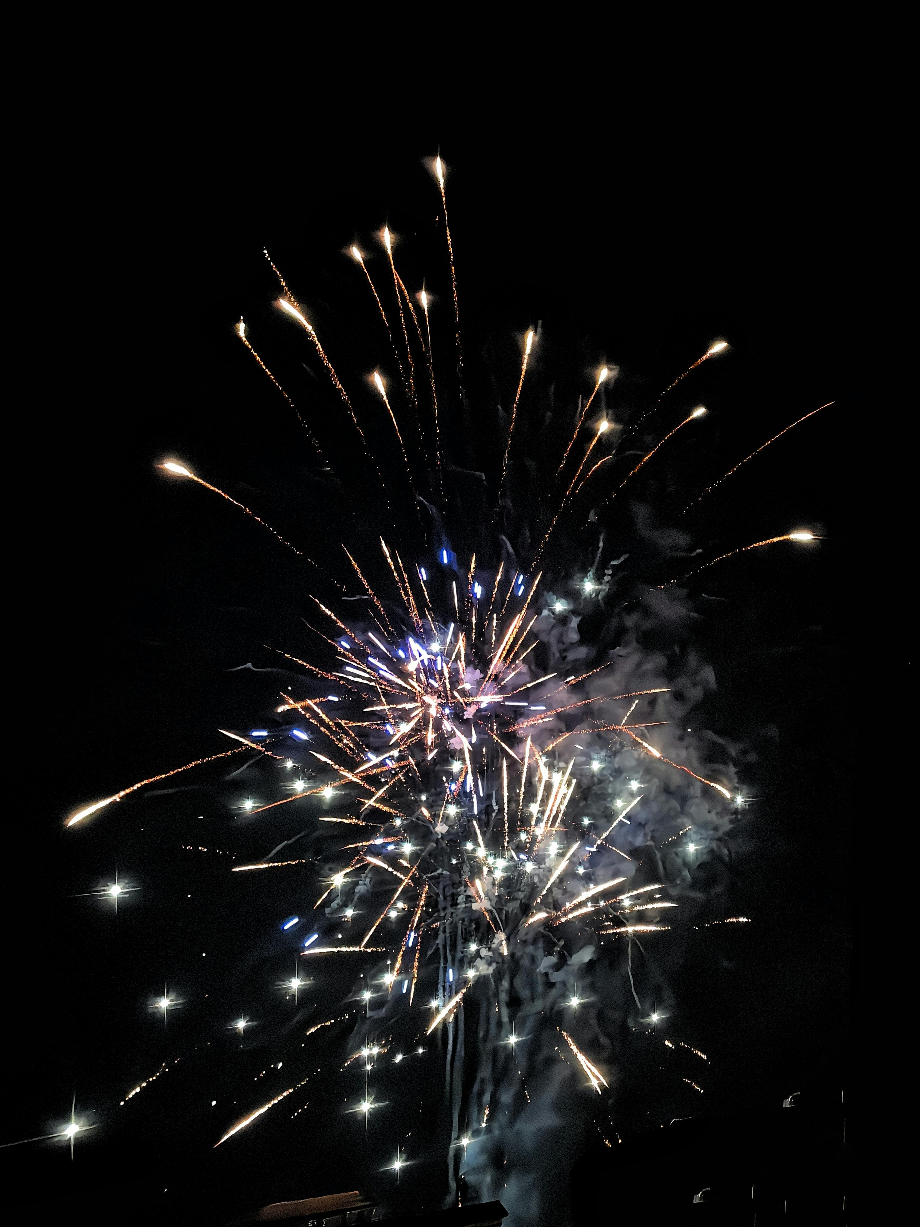 Vibrant fireworks exploding at night, creating a stunning visual display.