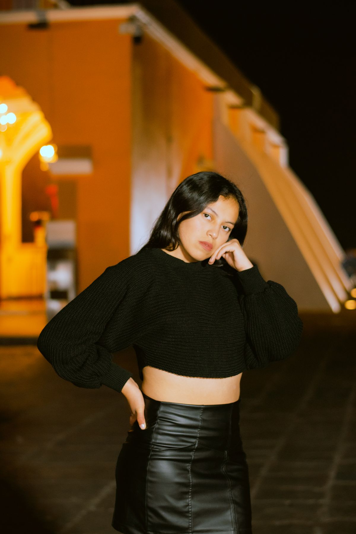 Latina woman wearing a bright color-blocked outfit with vivid tones