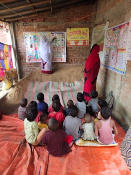 Children in a rural Indian classroom listen attentively to a lesson, highlighting educational efforts in local communities.