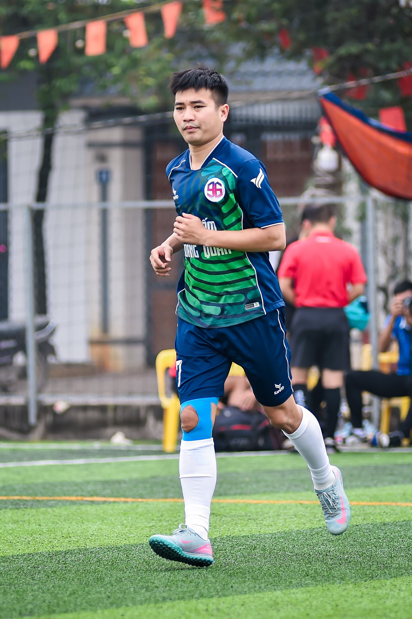A young soccer player in action on a vibrant field in Hà Nội, Vietnam.