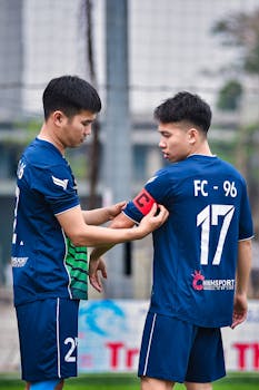 Two soccer players getting ready for a match on a field in Hanoi, Vietnam.