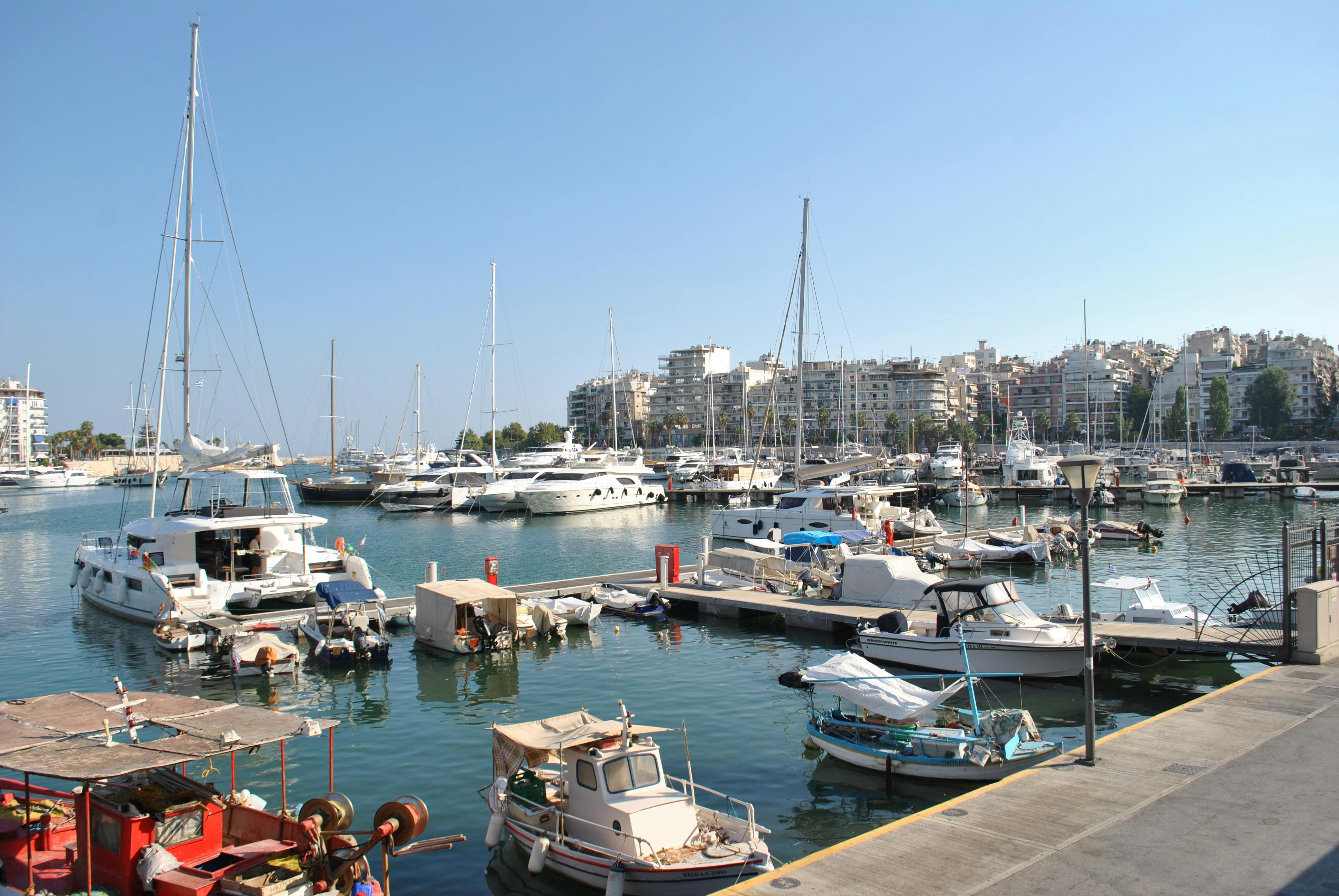 A picturesque marina filled with boats under a bright blue sky, perfect for travel stock photos.