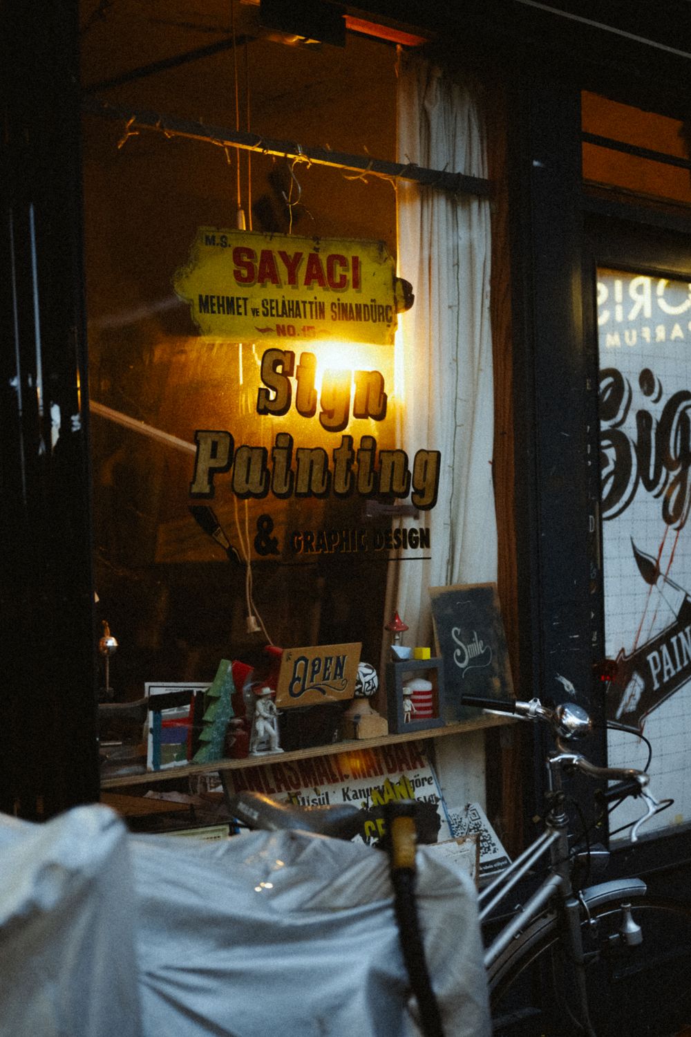 Vintage storefront of a sign painting shop, photo by Tolga Ahmetler on Pexels